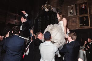lifting-bride-and-groom-on-dance-floor-at-wedding-reception-fun-wedding-photography-by-suessmoments