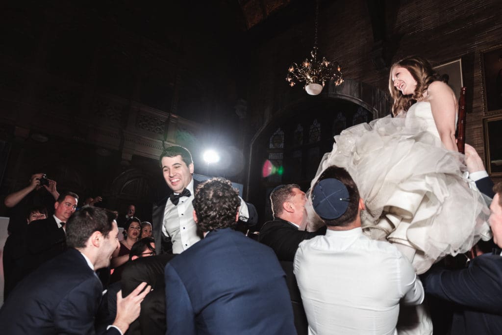 lifting-bride-and-groom-on-dance-floor-at-wedding-reception-fun-wedding-photography-by-suessmoments