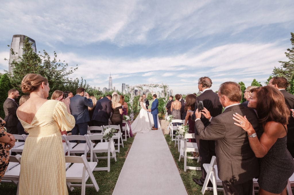 outdoor-ceremony-with-nyc-skyline-views-at-liberty-house-restaurant-new-jersey-by-suessmoments