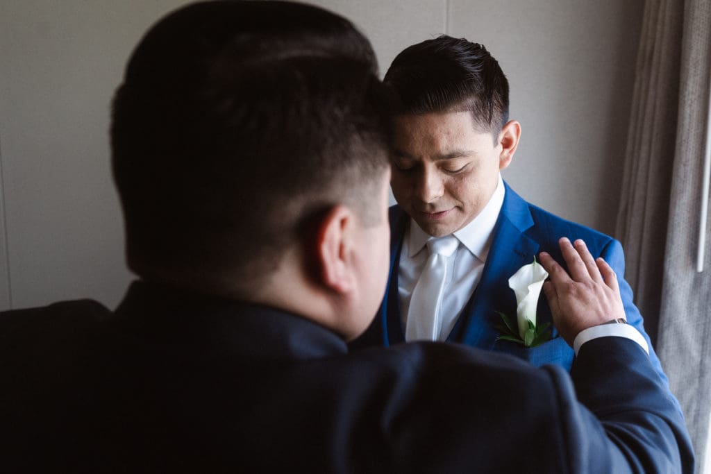 groom-getting-ready-by-a-window-suessmoments-photography
