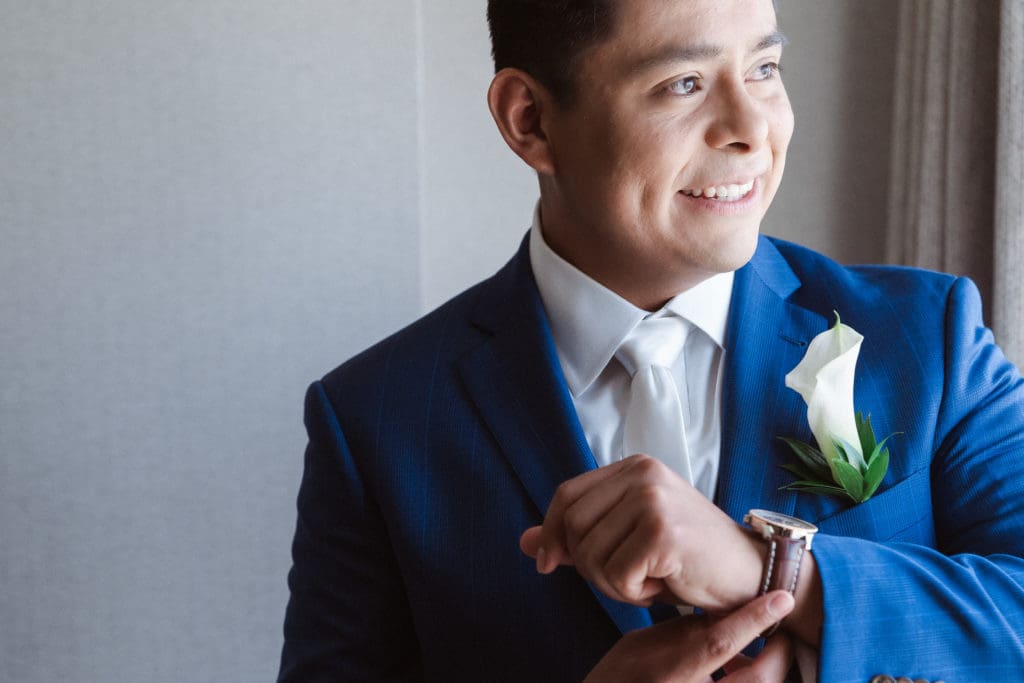groom-getting-ready-by-a-window-suessmoments-photography