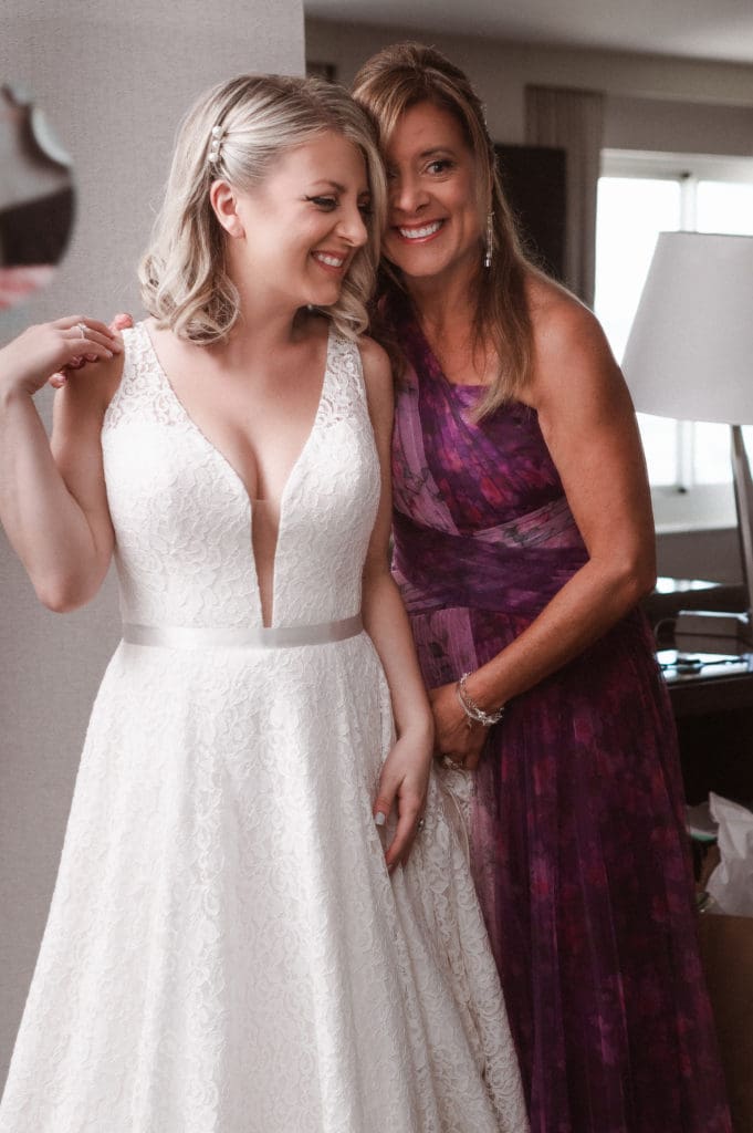 happy-mother-of-bride-with-bride-looking-in-mirror