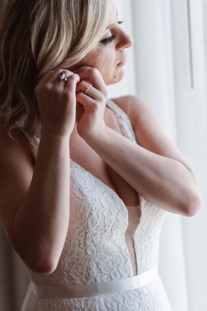 bride-putting-on-earrings