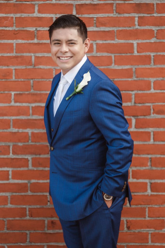 groom-portrait-by-brick-wall