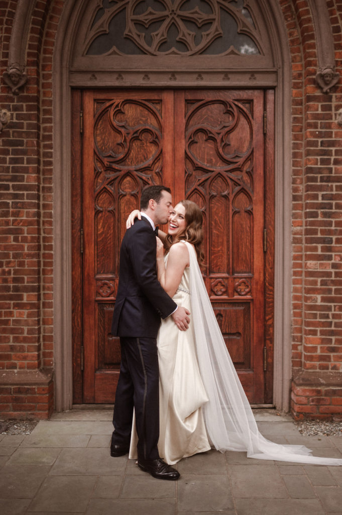 couple-posing-in-front-of-doors-nyc-photographer-wedding-suess-moments