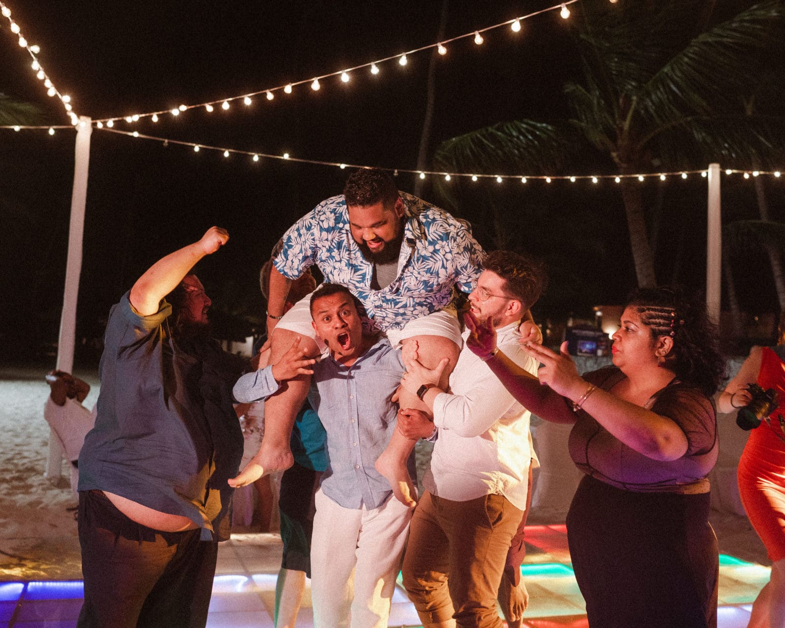 groom-being-lifted-on-dance-floor-wedding-reception