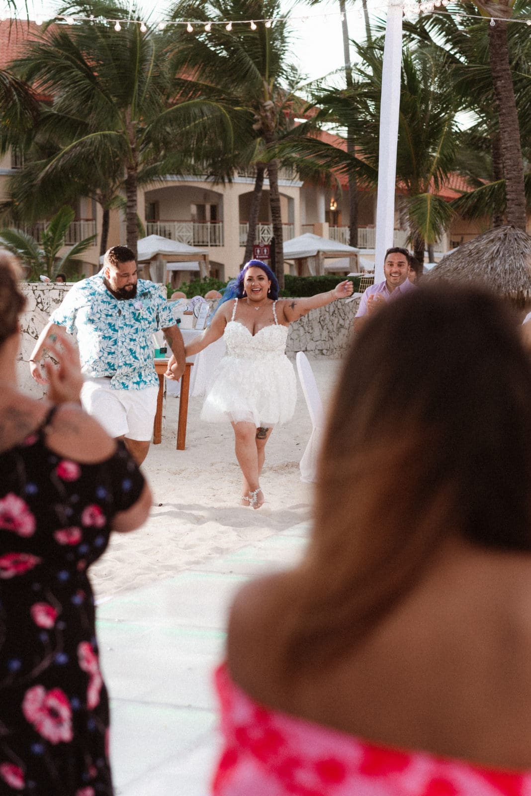 bride-and-groom-entrance-to-wedding-reception-on-the-beach