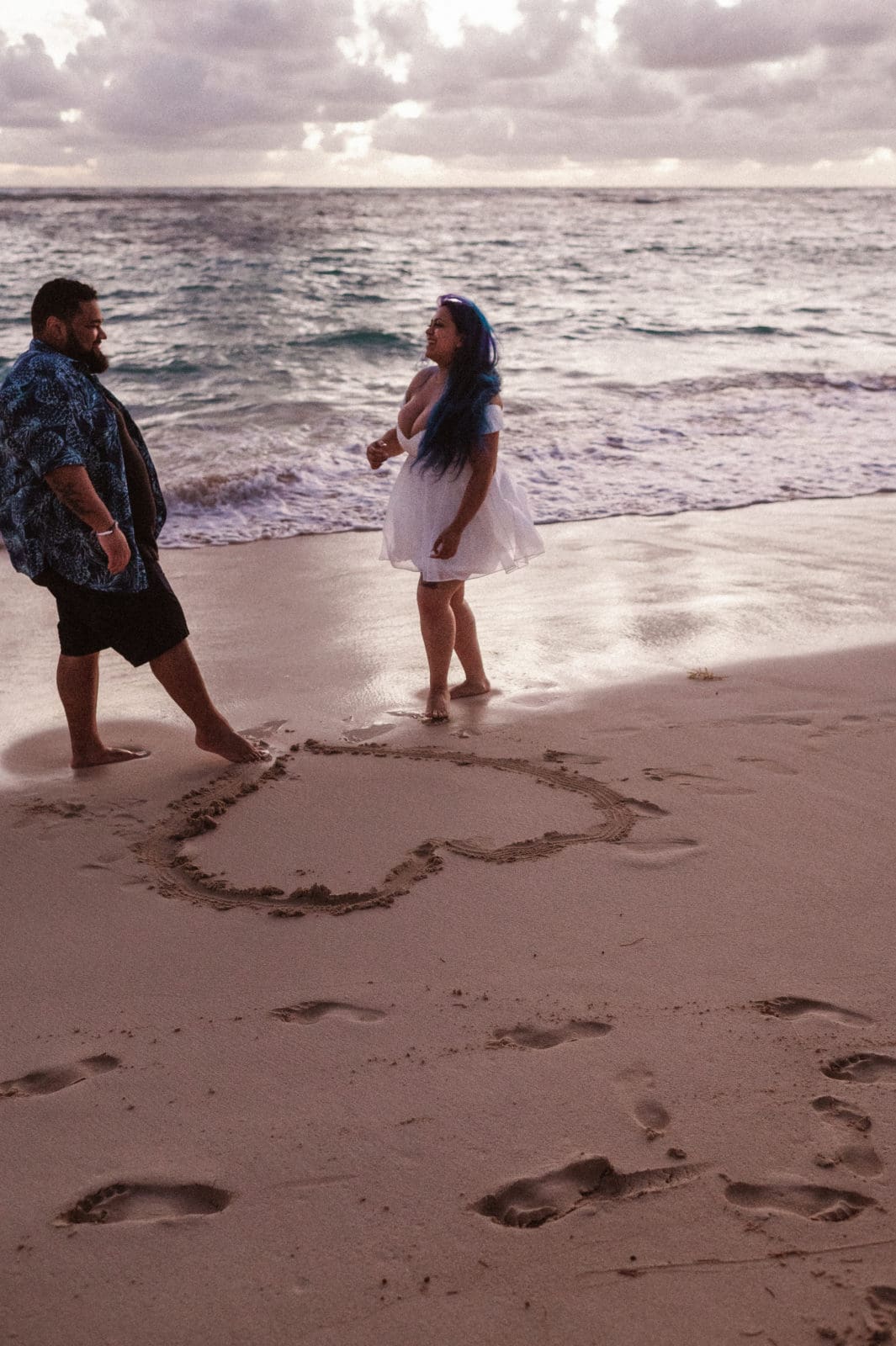 couple-drawing-heart-on-sand-beach-wedding-photos-by-suess-moments