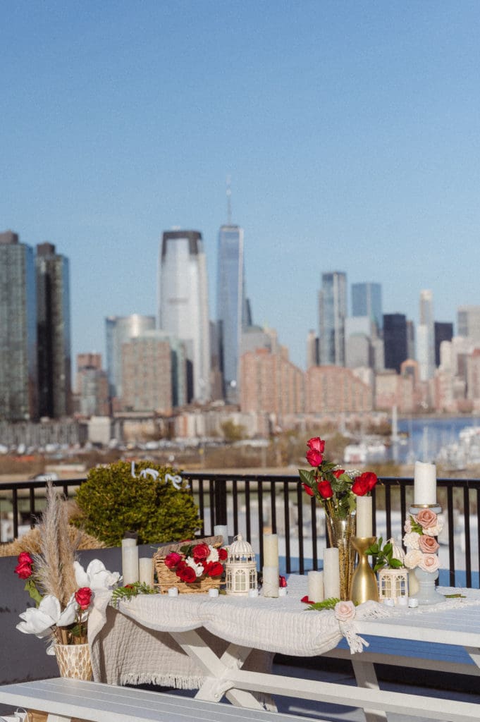 rooftop-jersey-city-nj-with-nyc-skyline-views-engagement-photos-picnic-by-suess-moments