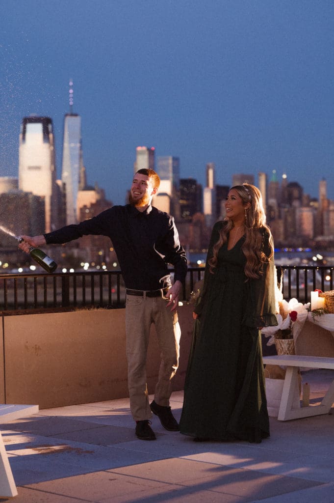 champagne-shower-nyc-skyline-jersey-city-rooftop-engagement-photos-by-suess-moments