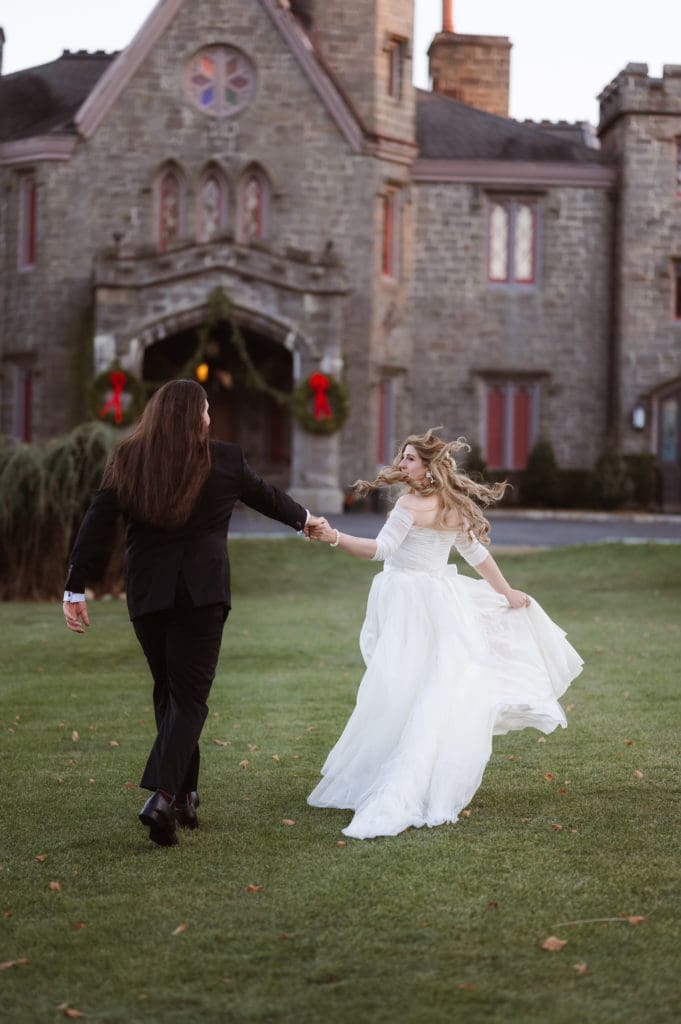 fun-candid-action-running-portrait-of-bride-and-groom-whitby-castle-winter-wedding-suess-moments-wedding-photographer