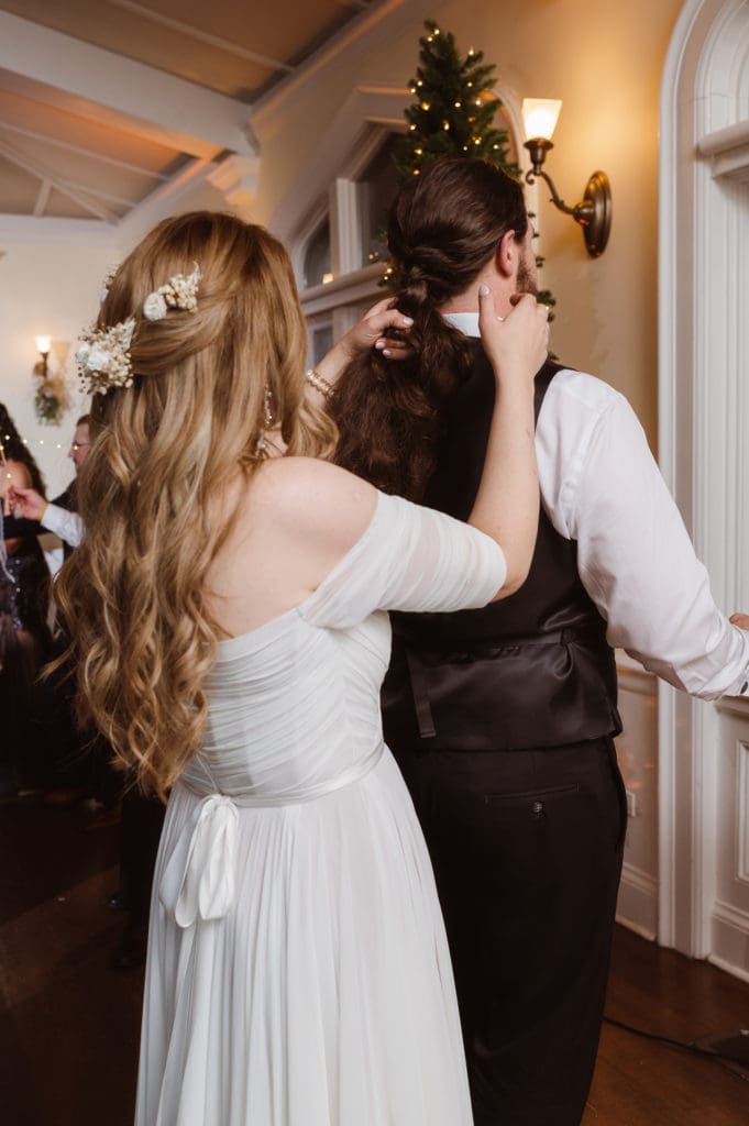 bride-braiding-groom-hair