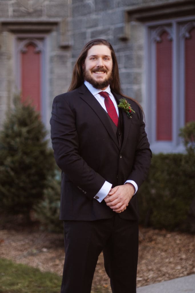groom-portrait-outside-winter-wedding-whitby-castle-suess-moments-wedding-photographer