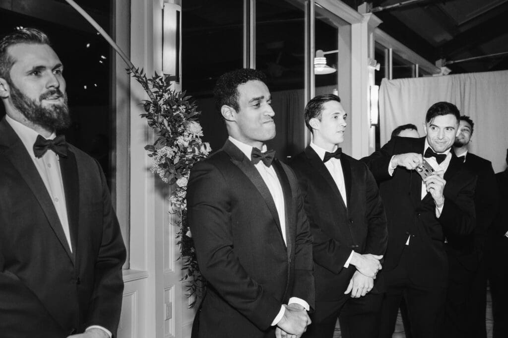 groom-waiting-for-his-bride-groomsman-taking-a-film-photo