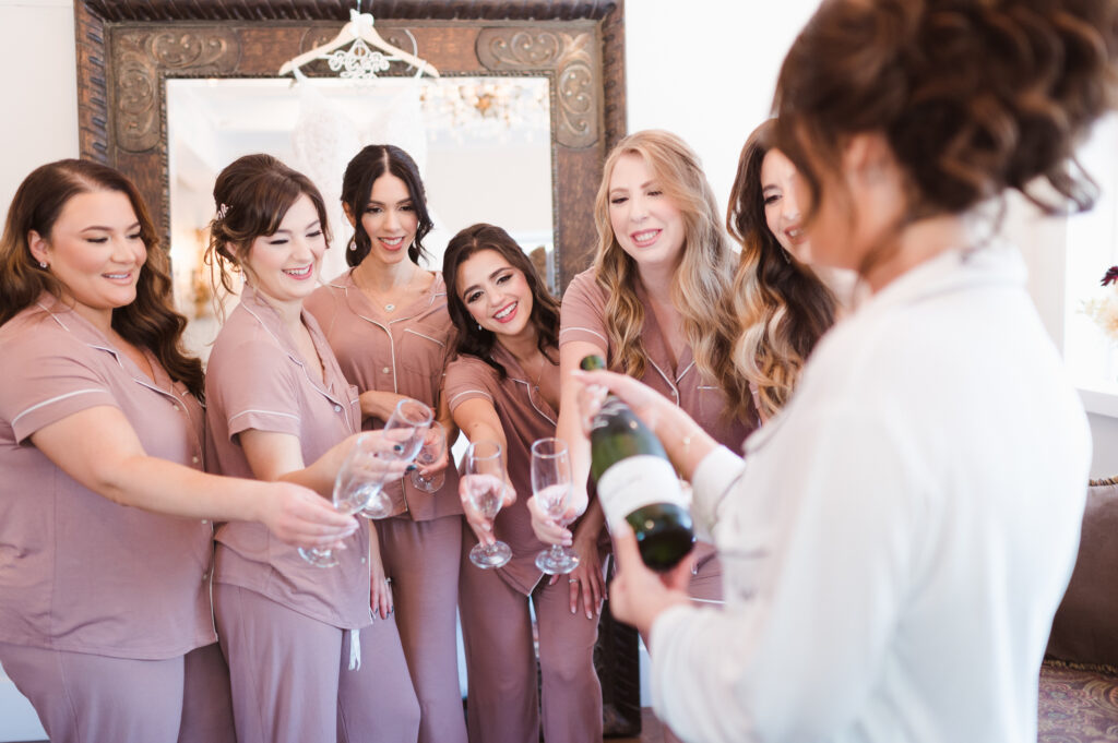popping-champagne-with-bridal-party