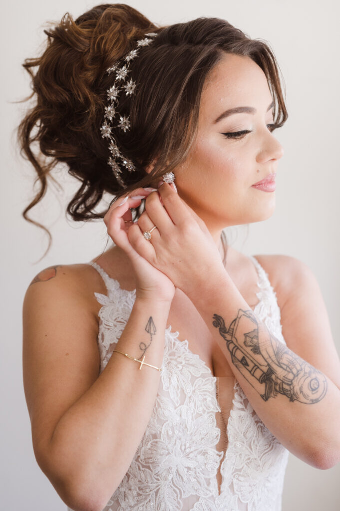 bride-putting-on-earrings