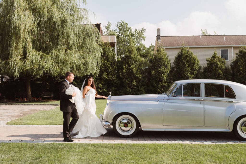 bride-and-groom-portrait-with-classic-rolls-royce-car