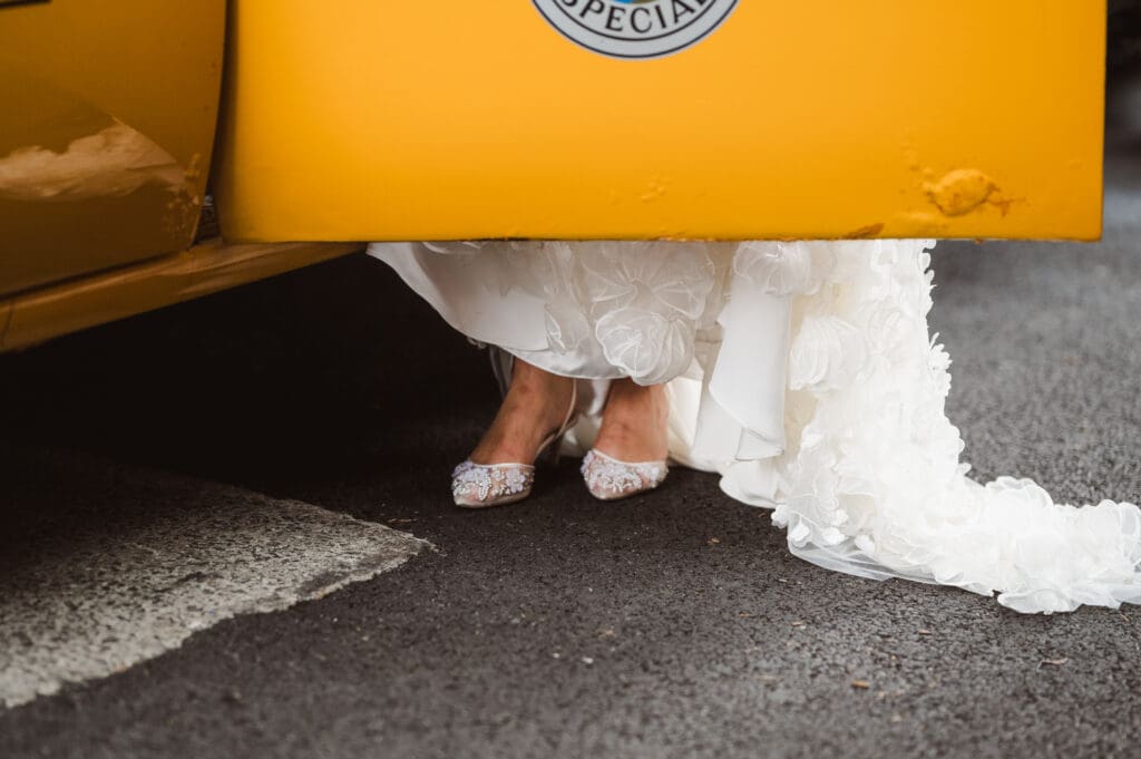 brides-shoes-stepping-out-of-yellow-vintage-nyc-taxi