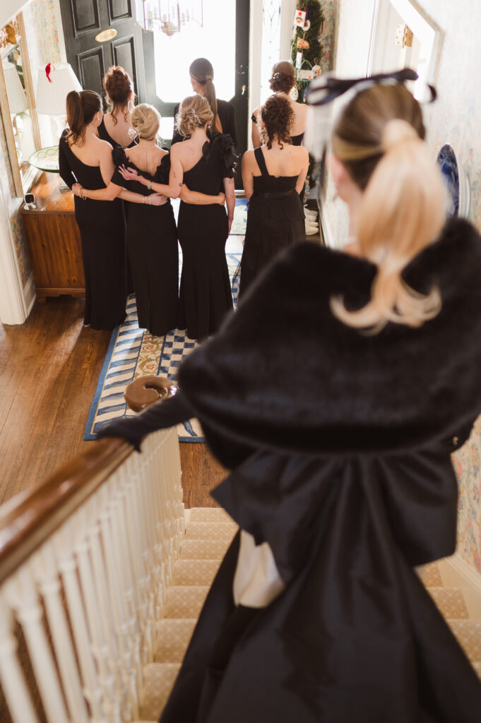 first-look-with-bridal-party-on-stairs