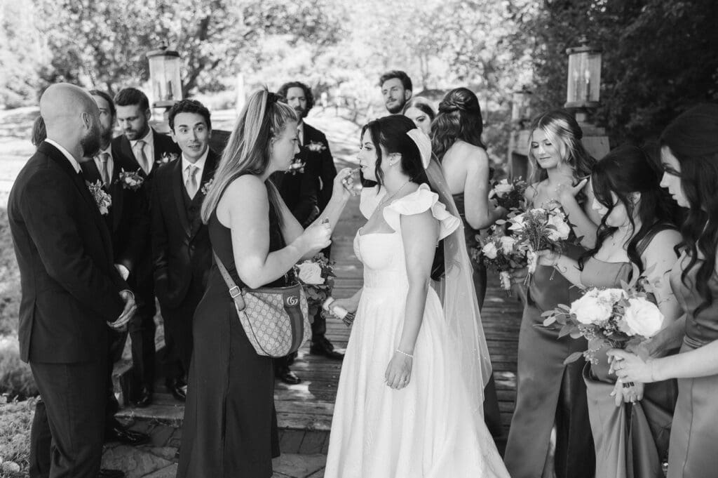 candid-wedding-photo-with-makeup-artist-at-bridal-party