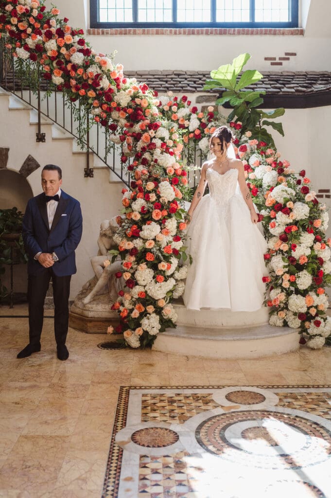first-look-on-staircase-at-pleasantdale-chateau-nj-wedding-photos-by-photographer-suess-moments