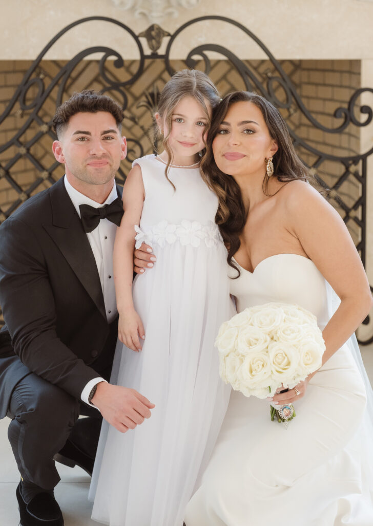flower girl wedding photo with bride and groom