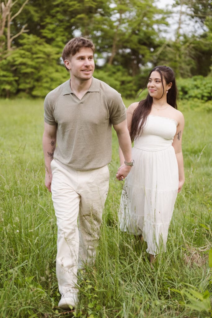 engagement photo shoot at cross estate gardens walking in grass