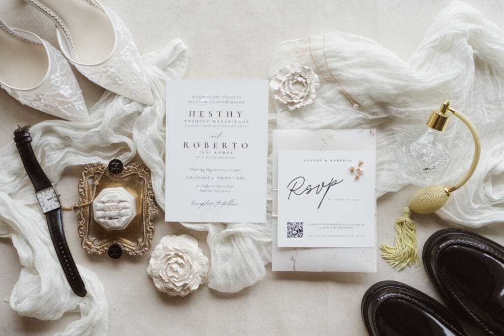 wedding day flatlay with invitations shoes and rings
