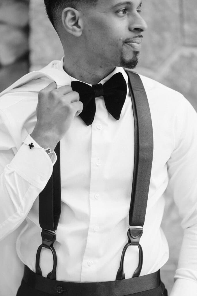 black and white detail shot groom wearing suit supply