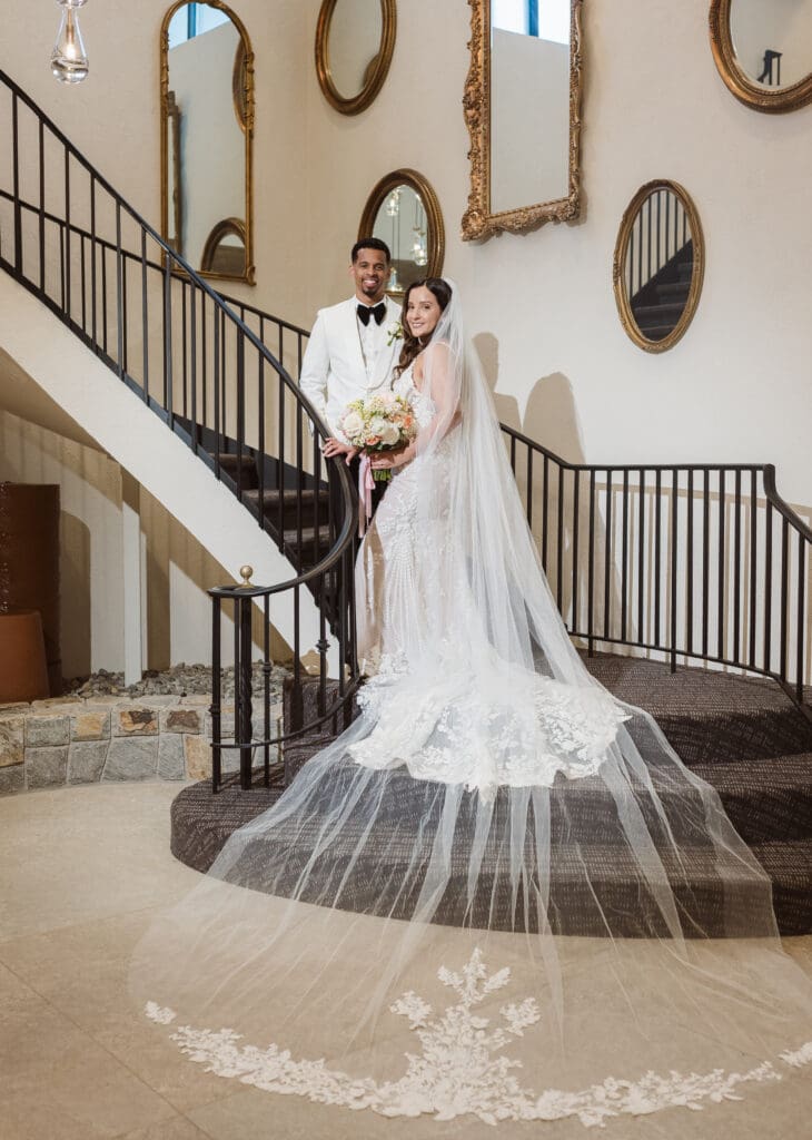 bride and groom on the staircase at perona farms the reserve