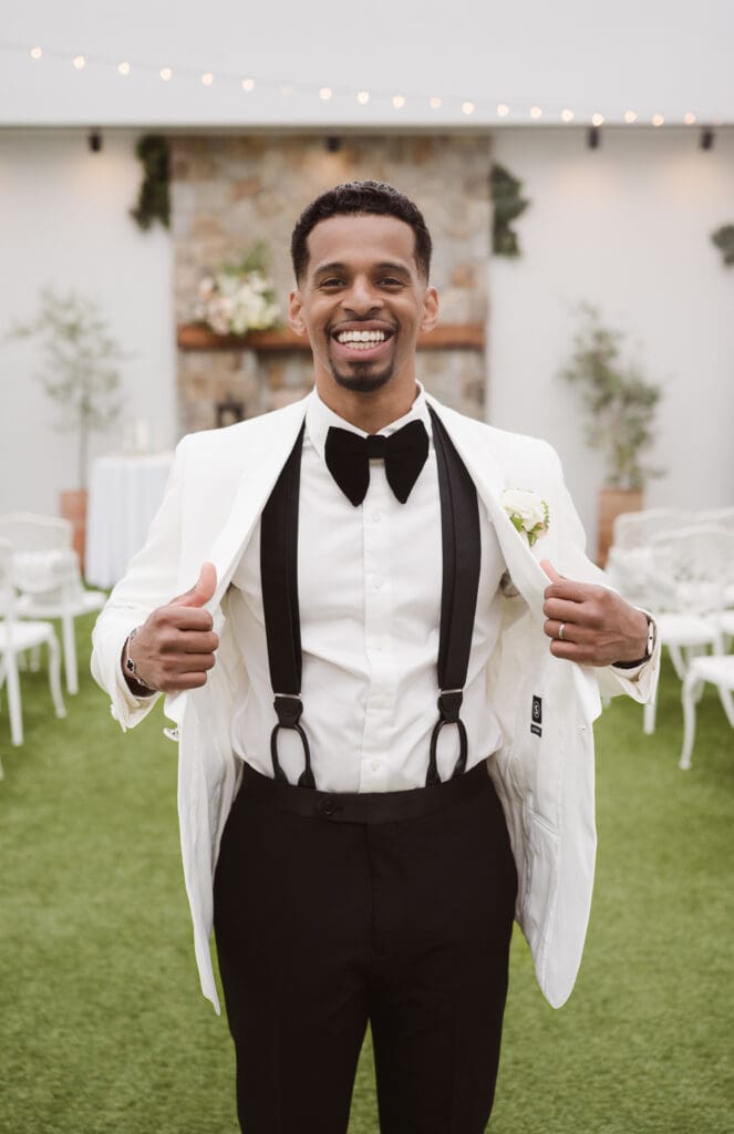 groom portrait wearing suit supply white tux at perona farms the reserve