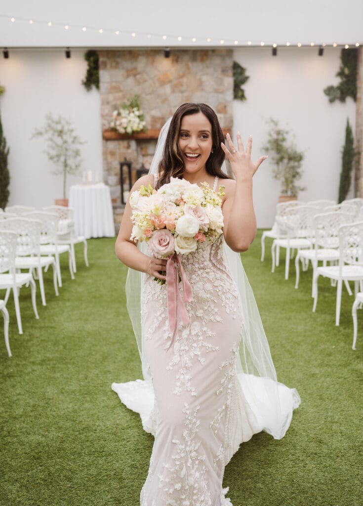 happy bride showing off wedding rings at the perona farms the reserve ceremony space