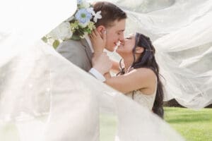 under the veil whimsical wedding portrait bride and groom
