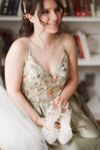 bride getting ready with the help from mom and maid of honor