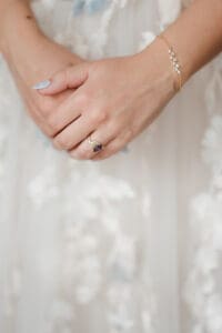 bride getting ready with the help from mom and maid of honor