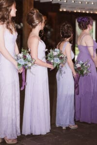 purple wedding bridesmaids dresses and bouquets